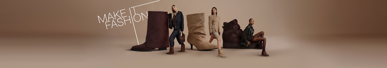 Campaign visual on a neutral beige background featuring three oversized boots in beige and dark brown tones. Three fashion models are posed around and on the footwear, wearing coordinated autumn-inspired outfits in shades of brown, taupe, and dark denim. White graphic lines frame the composition, and the text “MAKE IT FASHION” appears prominently in the upper left corner. The studio image combines fashion apparel and footwear in a modern, editorial-style presentation