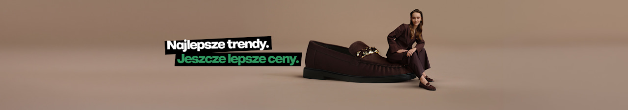 A campaign visual on a neutral beige background features an oversized dark brown loafer with a decorative gold-tone chain detail. Beside the shoe, a person wearing matching dark brown loafers and a coordinating outfit is seated in a fashion pose. Promotional text in Polish appears on the left side of the image, including the price “199.99”.