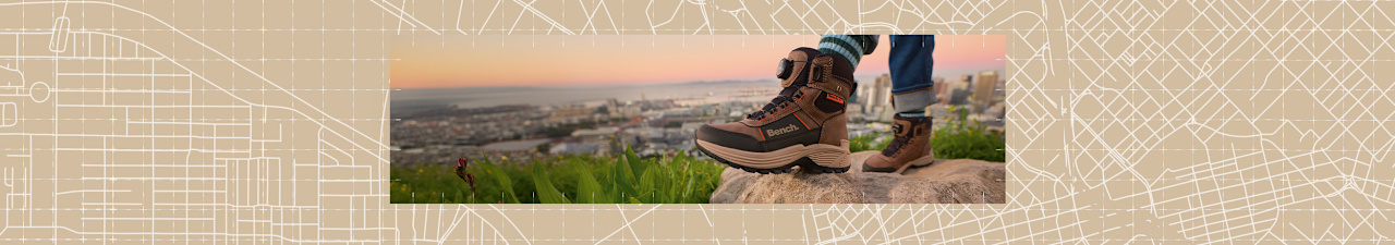 Explore Outdoor campaign visual showing sturdy hiking shoes on rocky terrain.