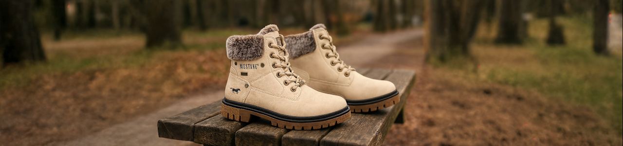 Two Kids boots on a bench in the forrest