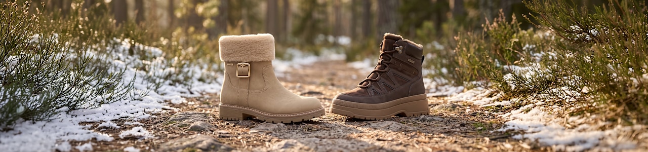 two women boots standing in a forest