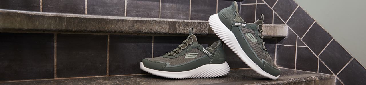 green skechers sneakers on stairs