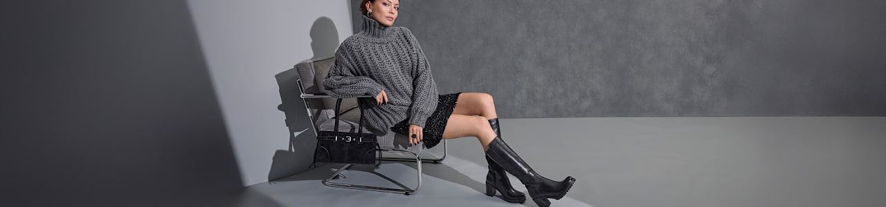 women sitting on a chair with black boots