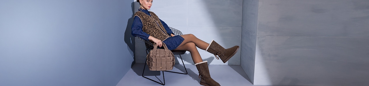 women sitting on a chair with cozy boots