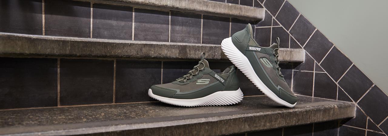 green skechers sneakers on stairs