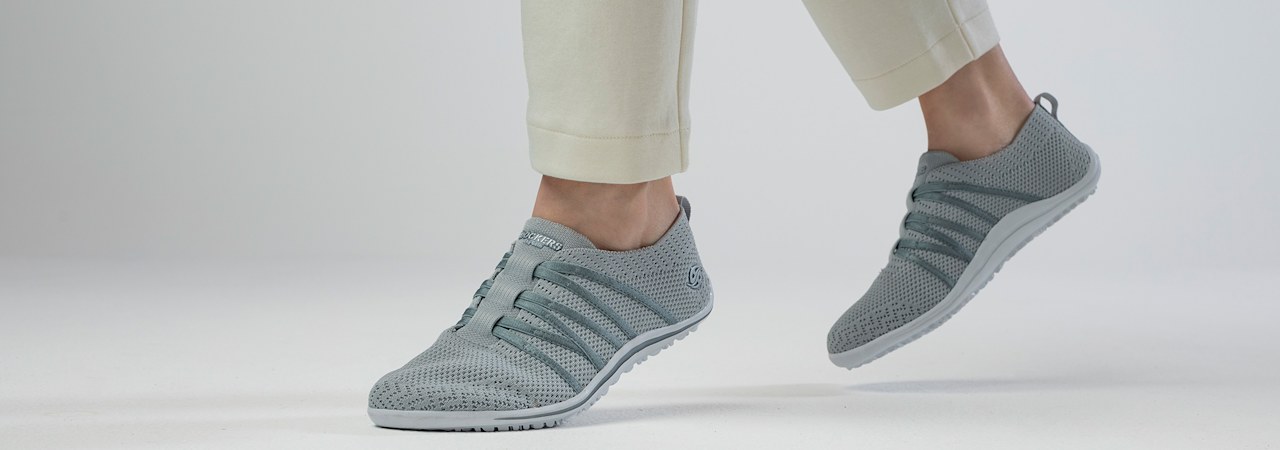Person in green sneakers walking