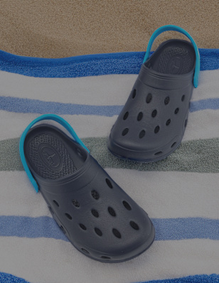 a pair of water shoes shoes on a beach towel