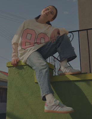 A young girl wearing light blue sneaker