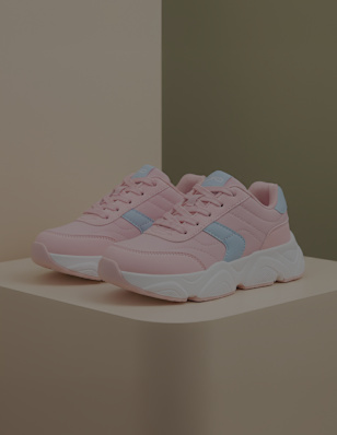 A kids sneaker on a pedastal