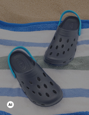 a pair of water shoes shoes on a beach towel