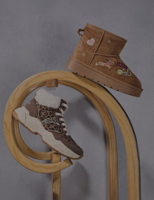 children cozy boot and a winter boot on a pedestal