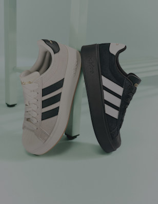 a black and a beige adidas sneaker