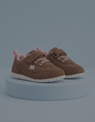first steps shoes standing on a blue pedestal