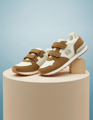 A kids sneaker on a pedastal