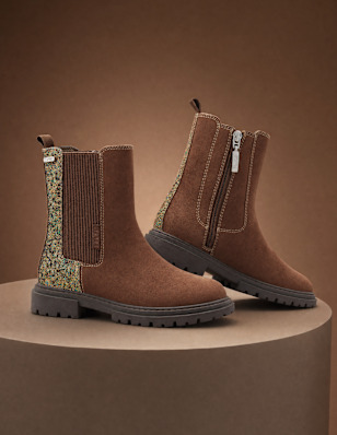 children ankle boots standing on a pedestak