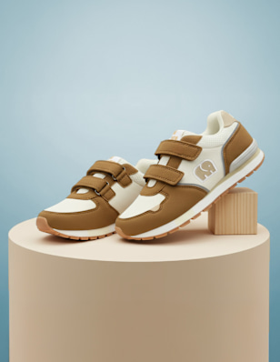 A kids sneaker on a pedastal