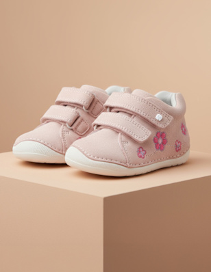 A kids sneaker on a pedastal