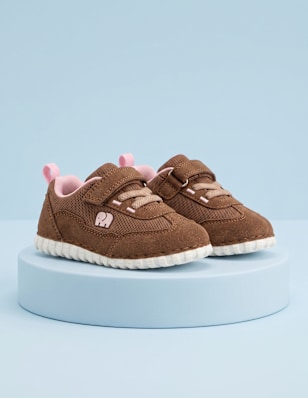 first steps shoes standing on a blue pedestal