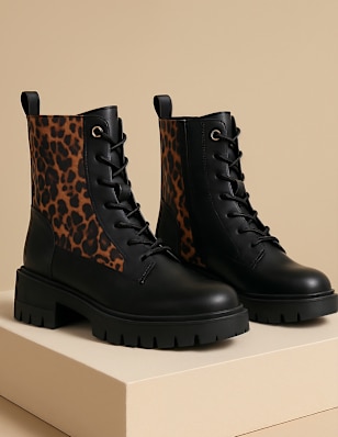Two Boots in front of a coloured Background