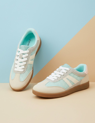 A pair of shoes in front of bi-coloured background