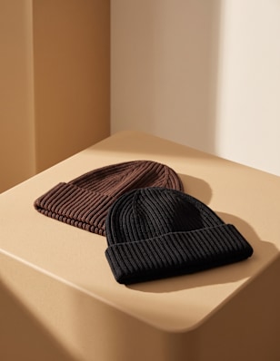 two women hats on a pedestal