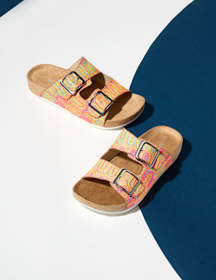 Two Shoes in front of a coloured background