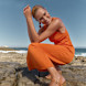 Woman in Sandals on rocks in front of ocean