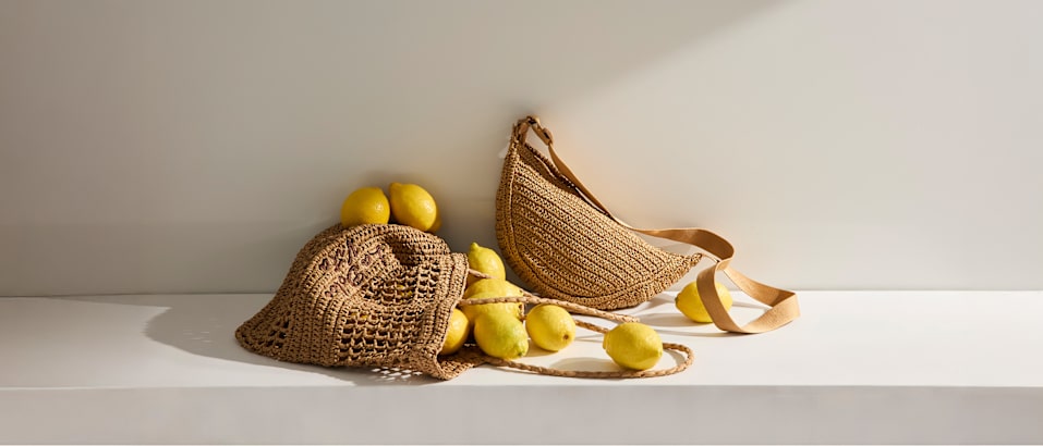 two bast bags with cirtus fruits