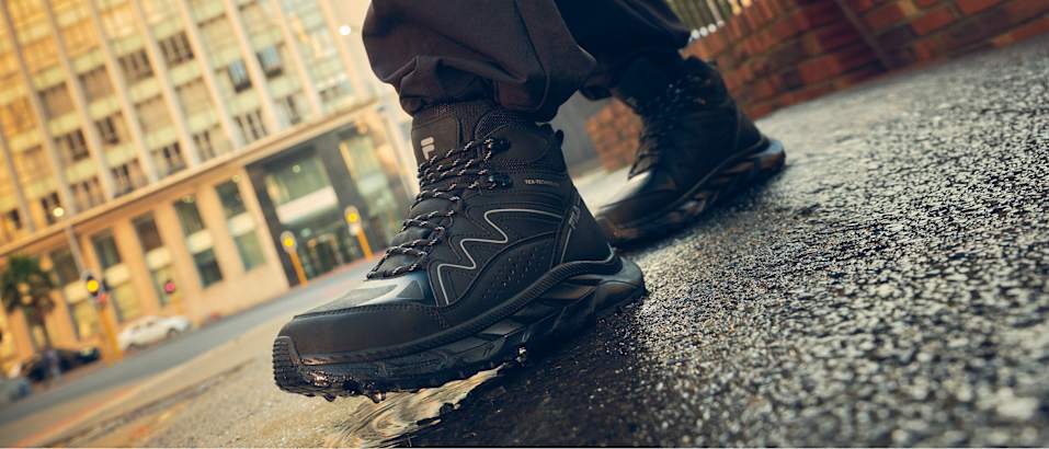 Close-up of a black outdoor boot designed for urban and outdoor exploration.