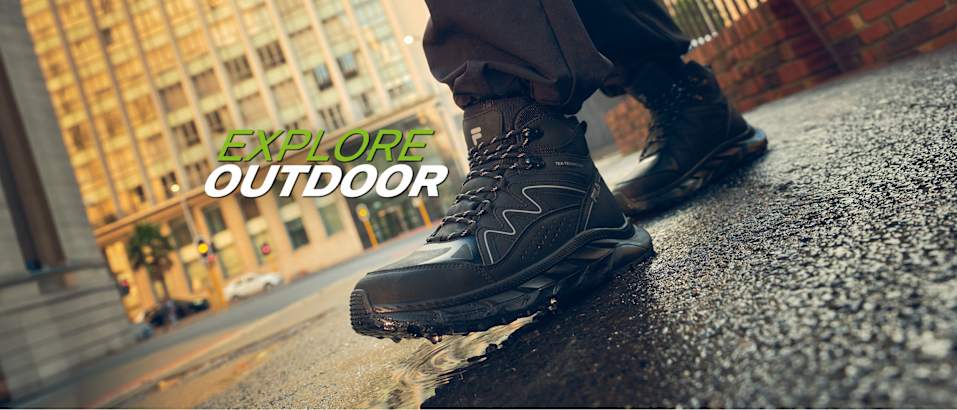 Explore Outdoor campaign visual with a black hiking boot on a wet street.
