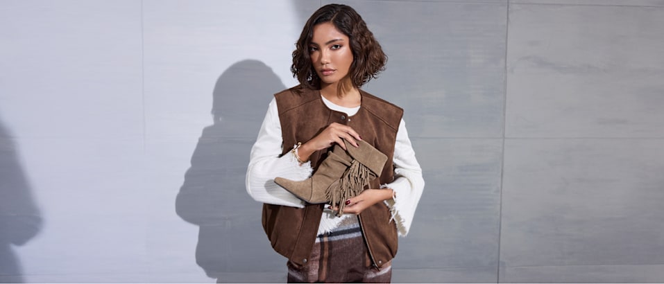 women with boots in her hand