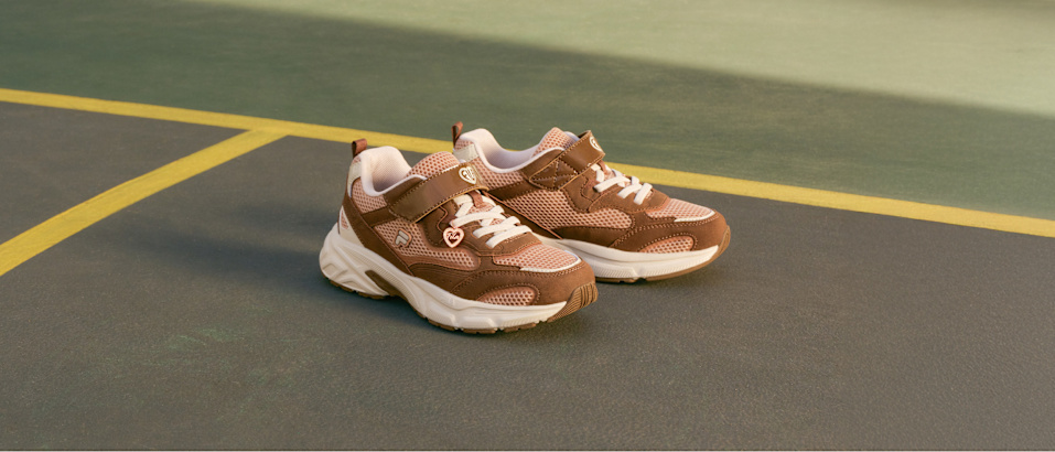 Brown sporty sneakers on an indoor court.