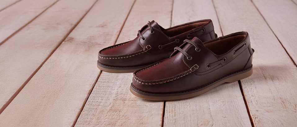 Dark brown loafers on wooden ground